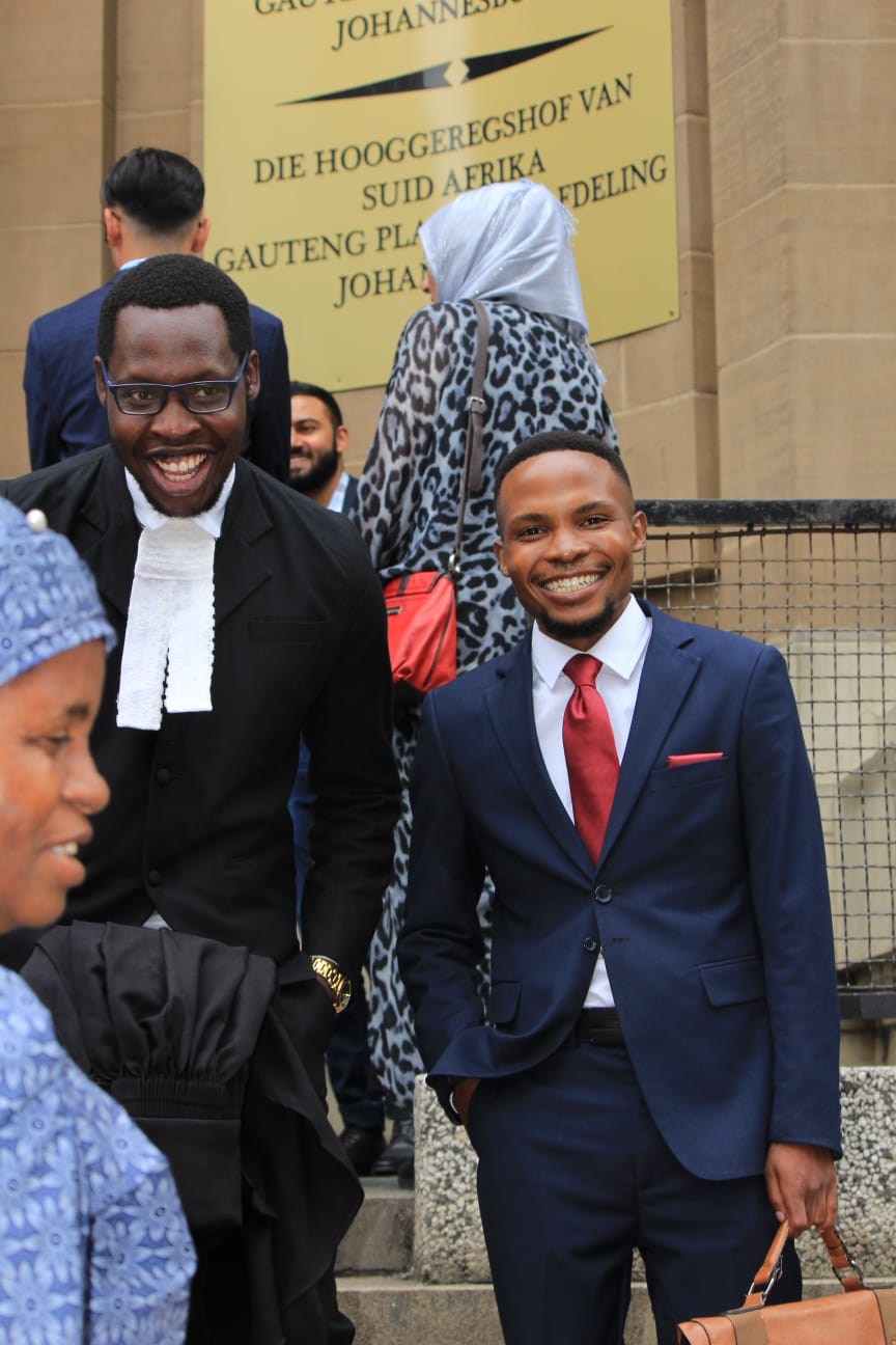 Advocate Matodzi Mavhungu, in advocate's robes, with Magic Rangoato outside the Johannesburg High Court